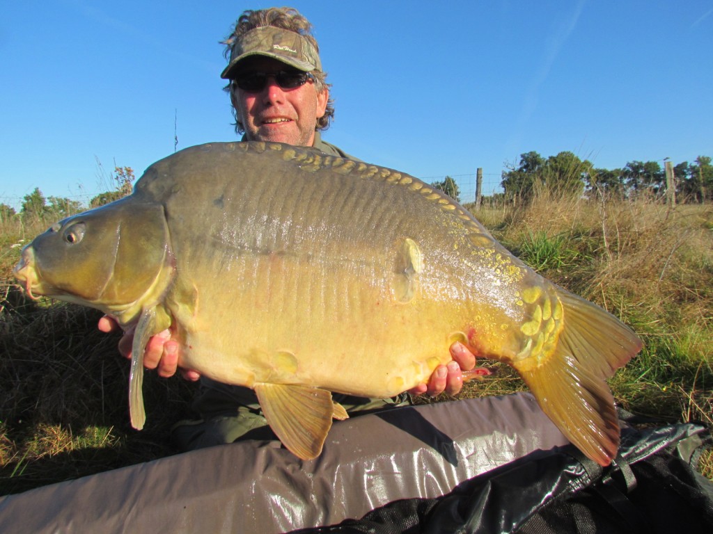 Trevor holding a large Carp caught while carp fishing in France