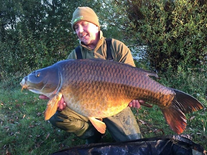 Simon holding his last carp that he caught