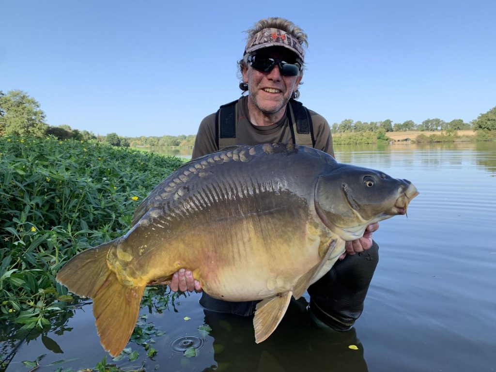 Trev with a huge leather carp